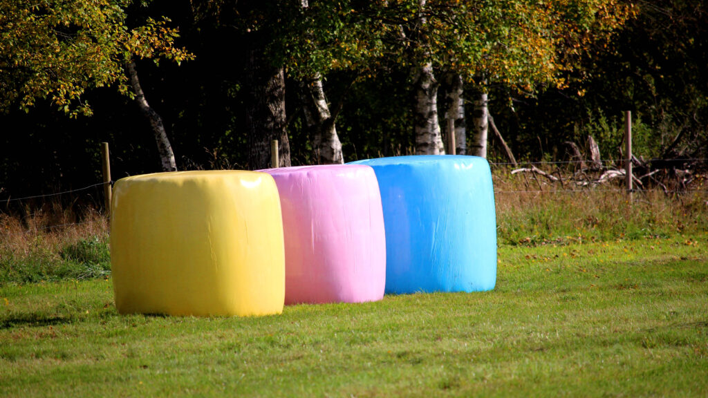 A yellow bale, a pink bale and a blue bale